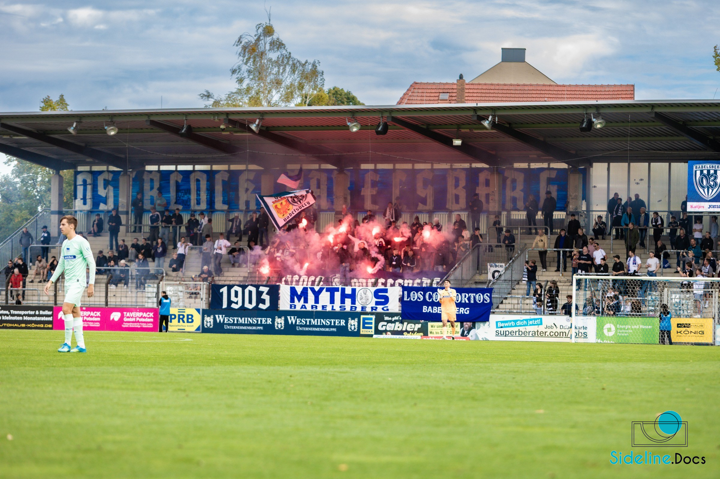 Red pyrotechnics behind the goal