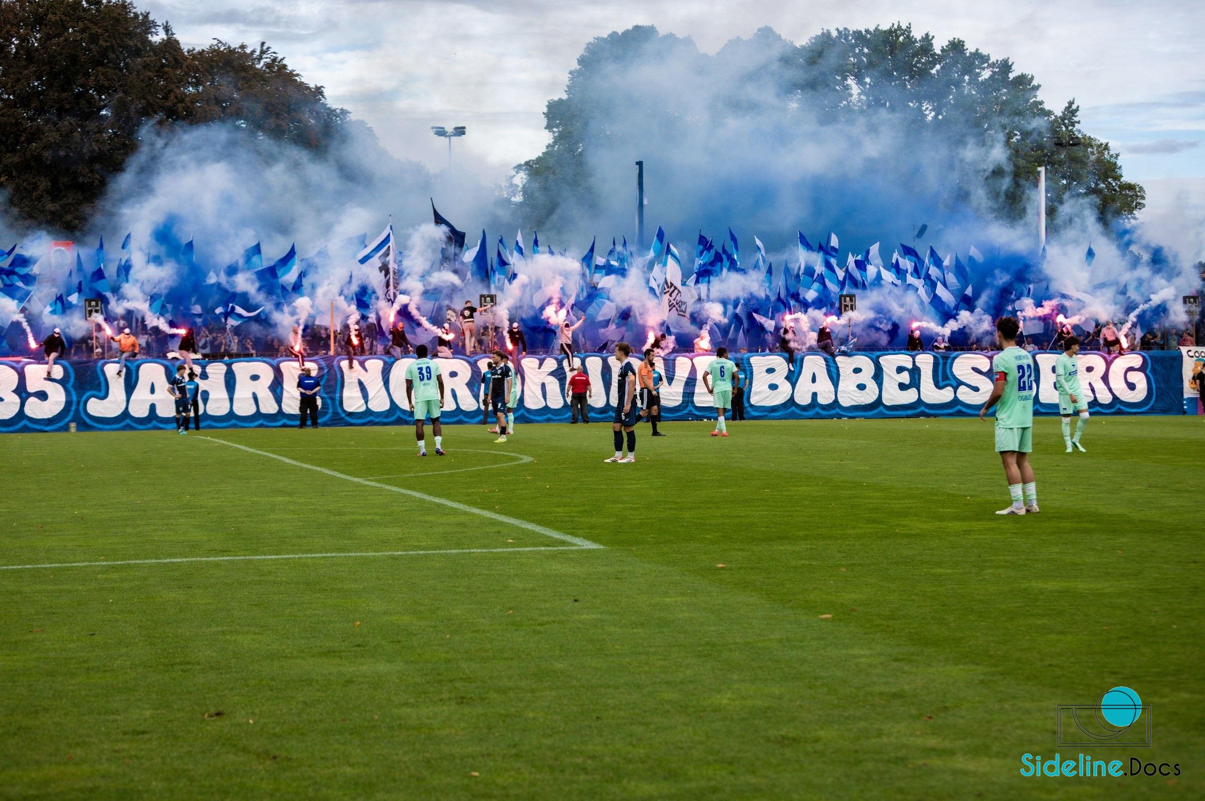 Full north stand with pyrotechnics and flags