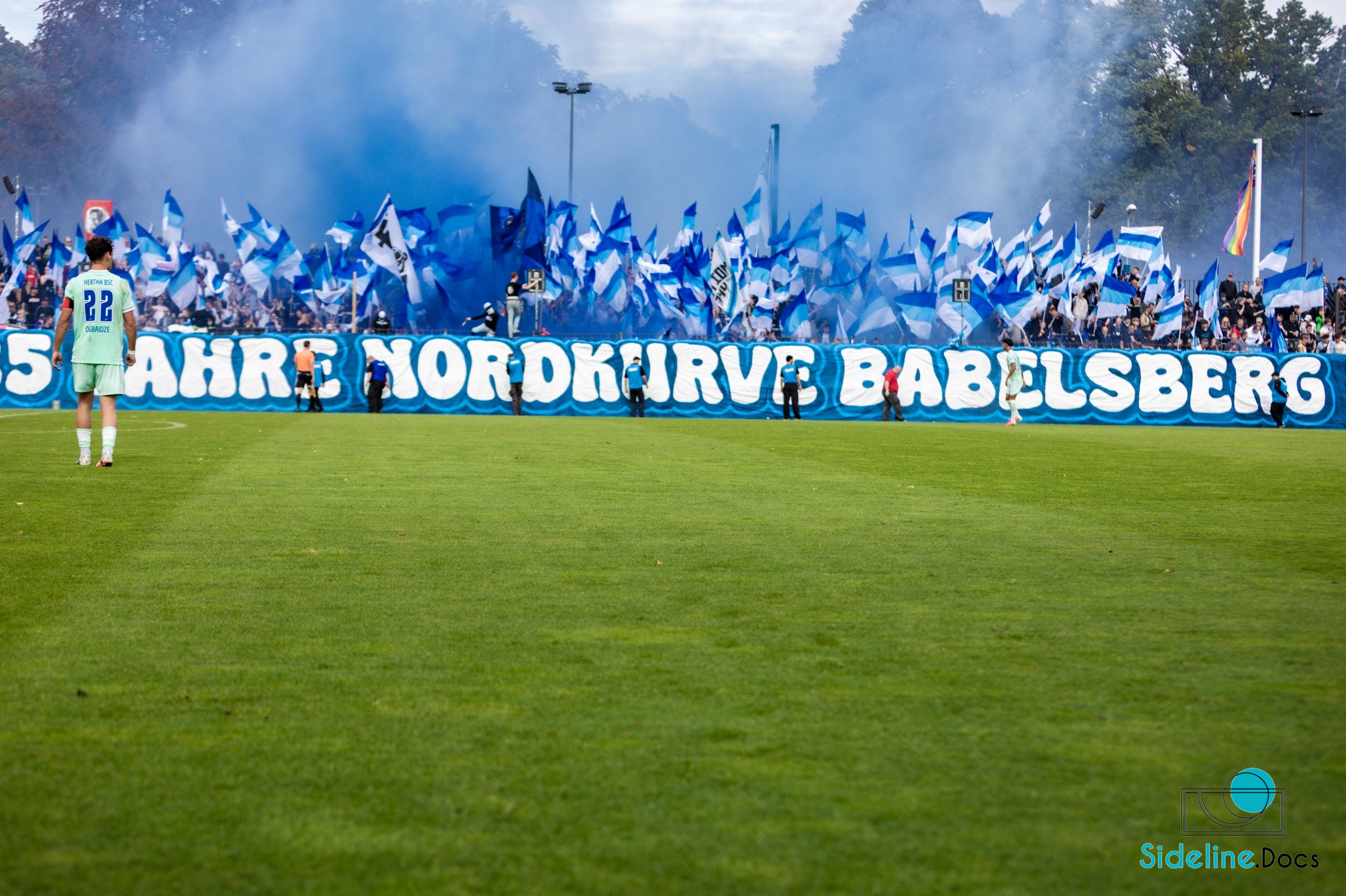 Hertha No. 22 in front of blue-and-white flags