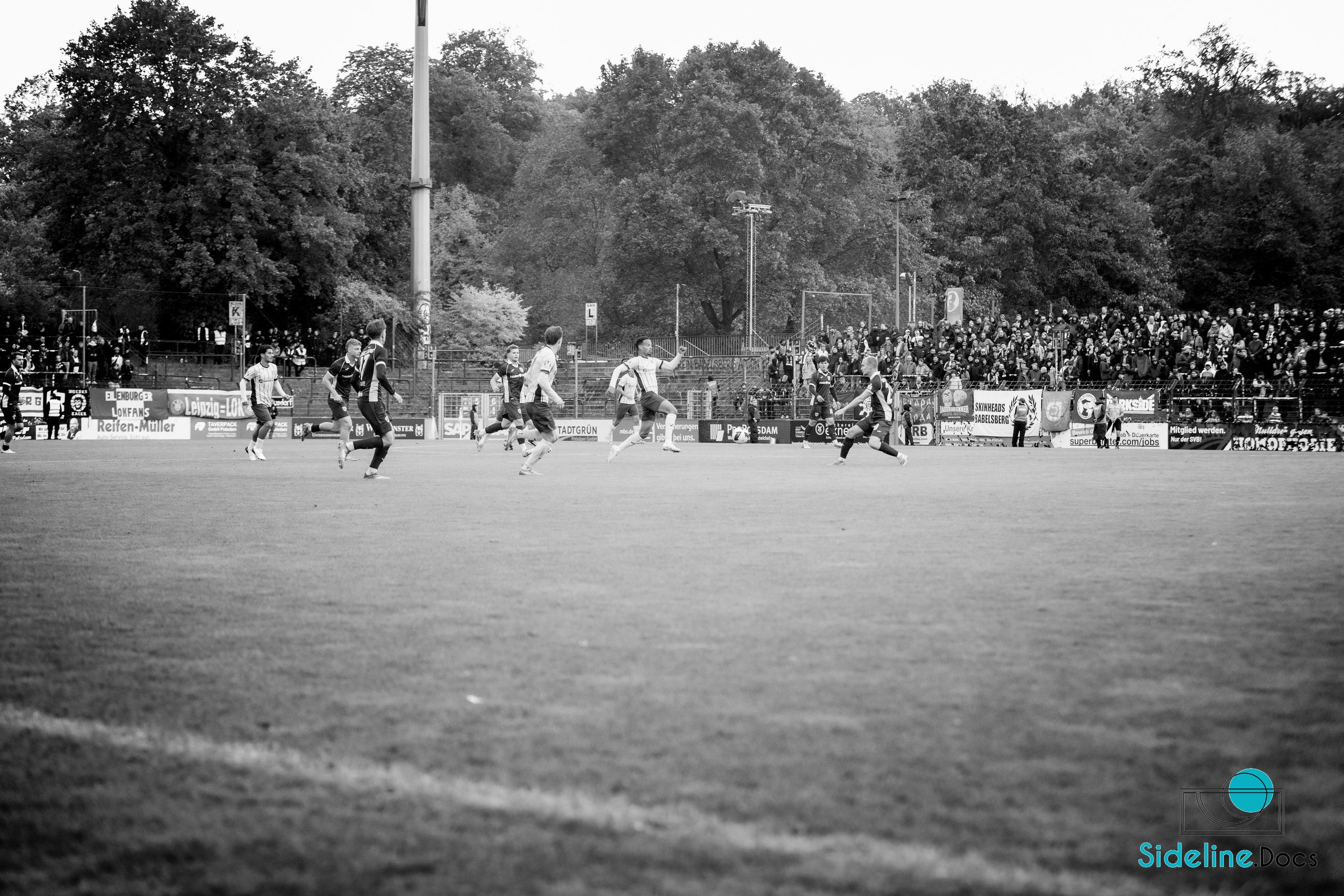 Midfield challenge in front of the packed terrace