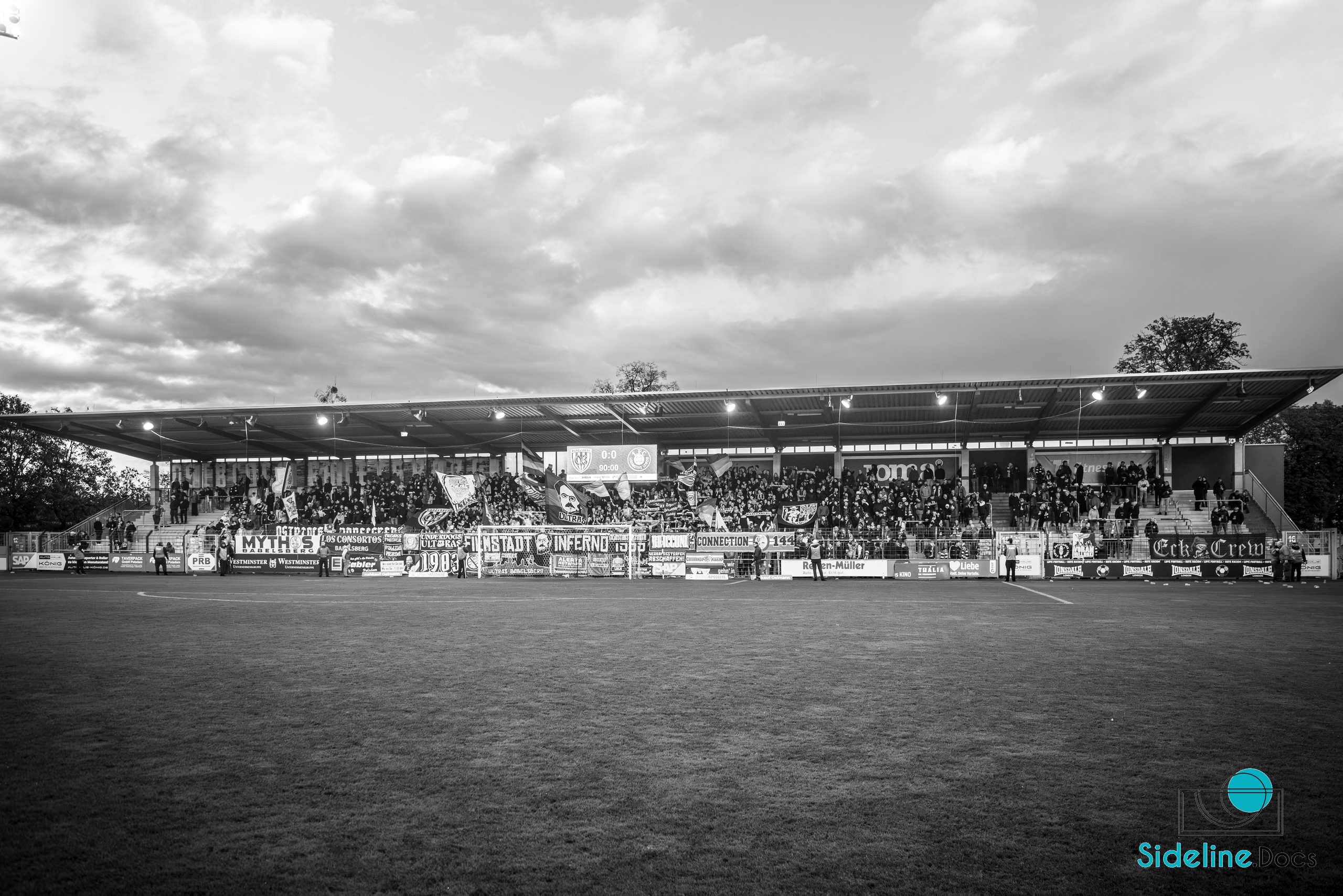 Covered home stand with Filmstadt Inferno banners, scoreboard at 0–0