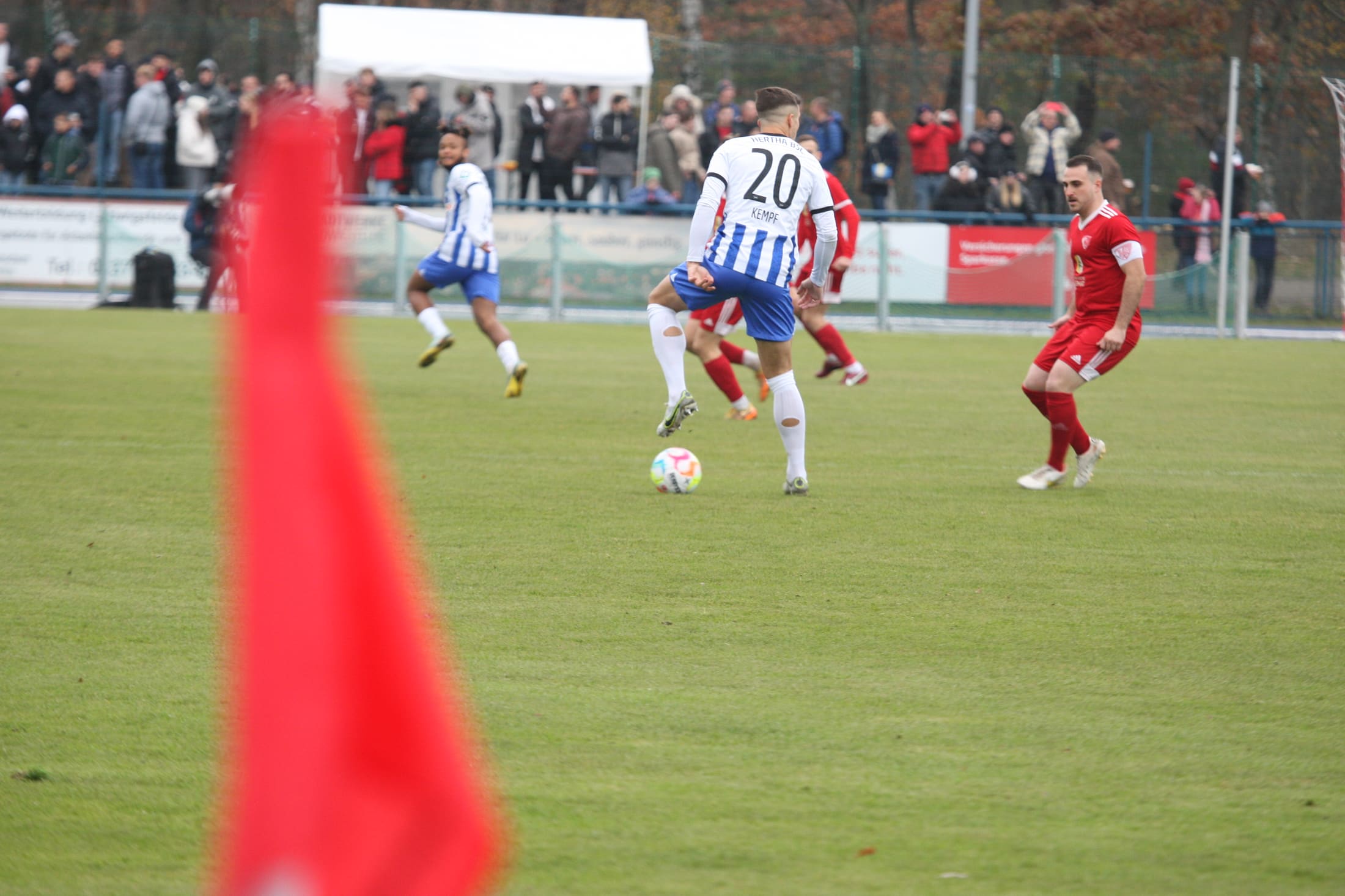 Sideline, corner flag and a challenge for the ball